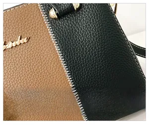 Détail macro d'un sac à main en cuir grainé de qualité avec coutures contrastées et logo