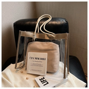 Detailed close-up of clear PVC tote bag with khaki fabric trim and rope handles