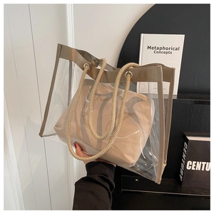 Detailed view of clear PVC tote bag with beige canvas inner pouch and thick rope handles