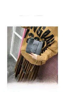 Detailed view of gray retro crossbody bag with arrow flap and chain strap for women