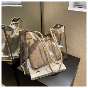 Detail of transparent PVC tote bag with champagne leather trim and cotton rope handles
