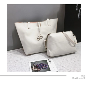 Detailed macro view of white lychee texture leather tote and matching crossbody bag set