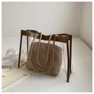 Close-up of transparent PVC tote bag with brown fabric trim and hemp rope handles