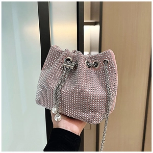 Détail du sac seau rose en strass avec lanières en chaîne argentée et pendentifs perles