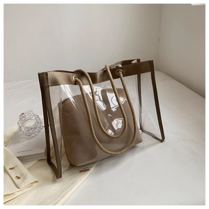 Close-up of clear PVC tote with brown canvas inner pouch and thick rope handles