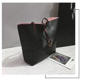 Detailed macro view of the lychee grain leather texture and golden metal ring on tote bag