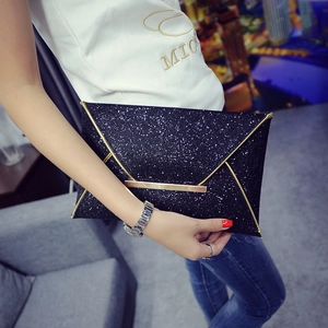 Modern black sequin envelope clutch bag with gold metallic V-shaped trim for formal events