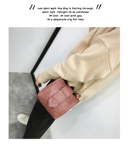 Crossbody dusty rose pink bucket bag with gold chain strap and leather buckle detail