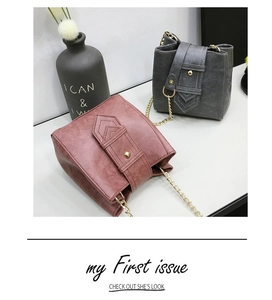 Detail of vintage bucket bags in dusty rose and charcoal gray with matte PU leather texture