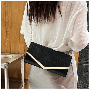 Detail of black glitter evening clutch featuring a gold V-frame and metal chain strap