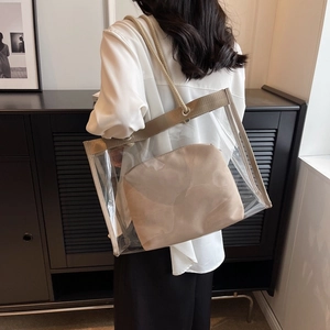 Chic transparent PVC tote bag with beige inner pouch and woven rope handles for beach trips