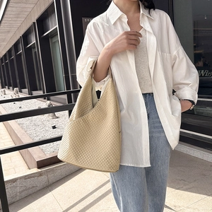 Schicke beige Tragetasche mit Webstruktur und dreieckiger Silhouette für Damen im Freien