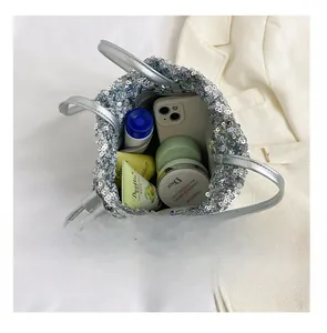 Vue intérieure montrant la grande capacité du sac seau à paillettes argentées avec accessoires