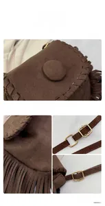 Detail view of brown suede saddle bag featuring woven edge stitching and long fringe tassels