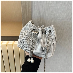 Gros plan du sac seau en strass étincelant avec chaîne argentée et détails perles