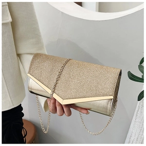 Detail of gold sequin evening clutch bag with V-shaped metal trim and chain strap