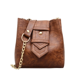 Brown vintage textured PU leather bucket bag with gold metal chain and rivet details