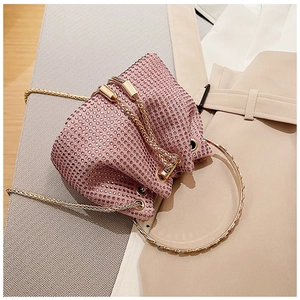 Détail du mini sac seau en strass rose avec chaîne dorée et poignée ronde en métal