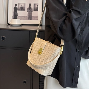 Bohemian woven straw bucket tote bag with large capacity and golden lock clasp detail