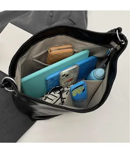 Detail view of large black tote bag interior showing pockets and spacious storage
