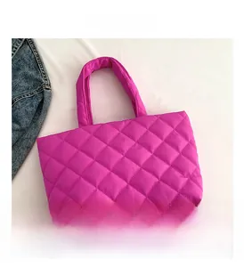 Detail view of the magenta quilted tote bag with soft padded texture and rhombus pattern