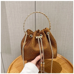 Détail du sac seau en strass avec poignée en anneau doré et chaîne coulissante