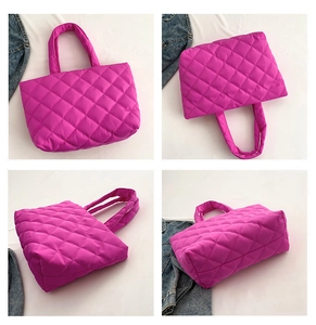Detail view of the rose red quilted tote bag showing rhombus pattern and soft padded texture