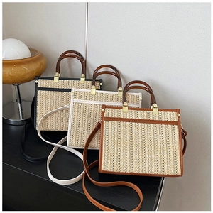 Three vintage straw tote bags with amber resin handles in black, cream, and brown colors