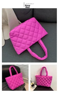 Macro display of quilted rose red tote bag with plush diamond patterns and thick handles