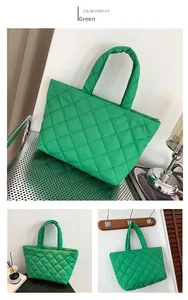 Detail of green quilted puffer tote bag with diamond stitching and soft padded handle