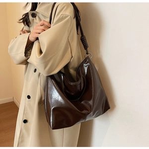 Detail of silver rings and leather knot on dark brown large hobo shoulder bag