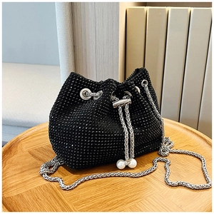 Gros plan du sac seau en strass noirs avec chaîne argentée et cordons en perles