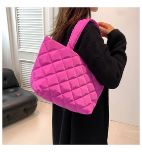 Quilted rose pink puffer tote bag with a diamond pattern texture and wide straps