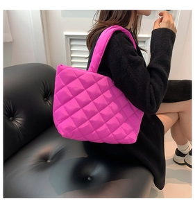 Detail of hot pink quilted tote bag with diamond stitching on high-quality nylon fabric