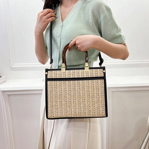 Retro handmade straw tote bag with tortoiseshell handles and black leather trim accents