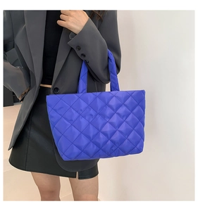 Close-up of Klein blue quilted tote bag showing rhombus texture on waterproof fabric