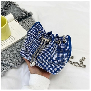 Sac seau bleu roi orné de strass scintillants et d'élégants cordons en perles blanches