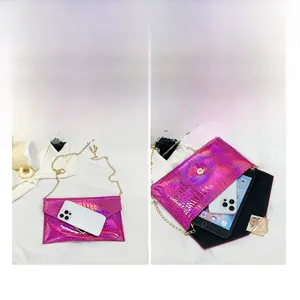 Macro view of magenta crocodile pattern envelope bag showing large internal capacity