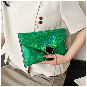 Detail of neon green envelope bag with crocodile texture and gold geometric buckle