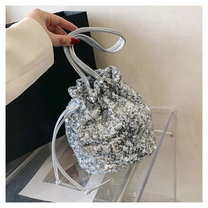 Détail du sac seau à paillettes argentées avec fermeture à cordon et bandoulière fine