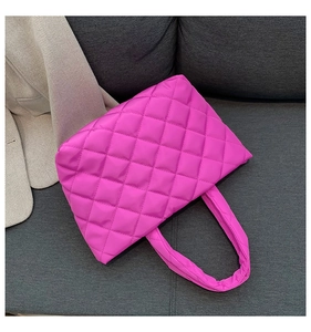 Top view of large magenta quilted nylon puffer tote bag with thick padded handles