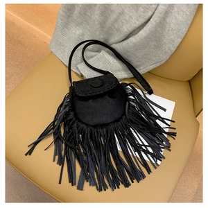 Close-up of black suede crossbody bag with long fringes and bohemian saddle design