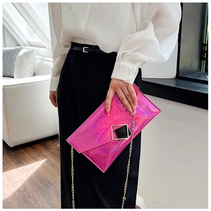 Detail of fuchsia holographic crocodile pattern envelope bag with gold chain strap