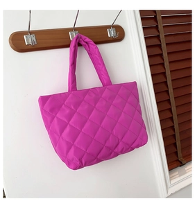 Detail of quilted fuchsia tote bag with puffy nylon fabric and wide shoulder straps