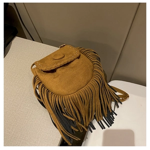 Detailed close-up of brown suede saddle bag with stylish long bicolored fringes
