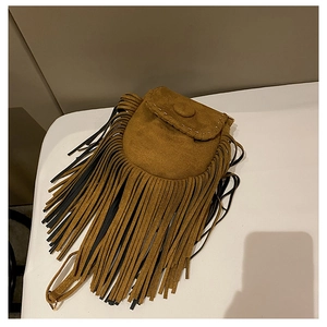 Close-up of vintage brown suede crossbody bag with decorative fringe and metal buckle