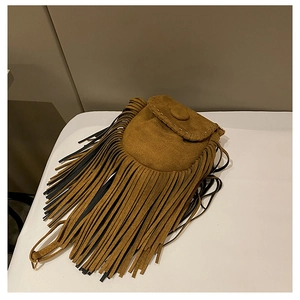 Detail view of brown faux suede saddle bag featuring long bohemian tassels and stitching