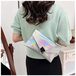 Macro shot of silver iridescent crocodile texture on envelope clutch with metal buckle