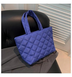 Detail of Klein Blue quilted tote bag showing its padded texture and soft fabric handles