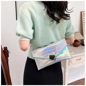 Detail of laser iridescent crocodile embossed envelope clutch bag with gold chain strap